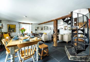 A beautiful spiral staircase leads down to the basement kitchen area.