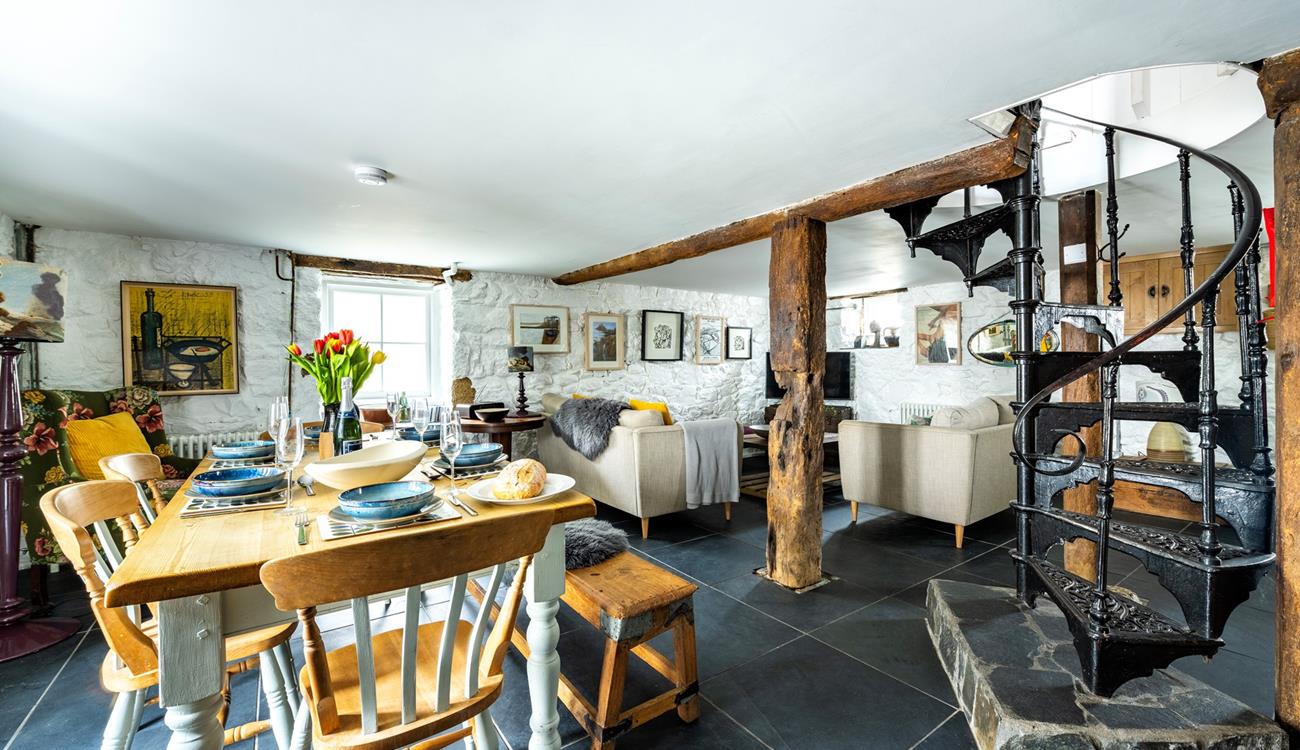 A beautiful spiral staircase leads down to the basement kitchen area.