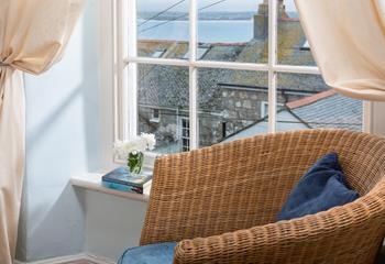 The sea view from the bedroom across the rooftops is peaceful, sit in the armchair and relax with a good book.