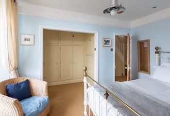 Bedroom 1 has a walk-in dressing room area with fully fitted painted wood cupboards and drawers.