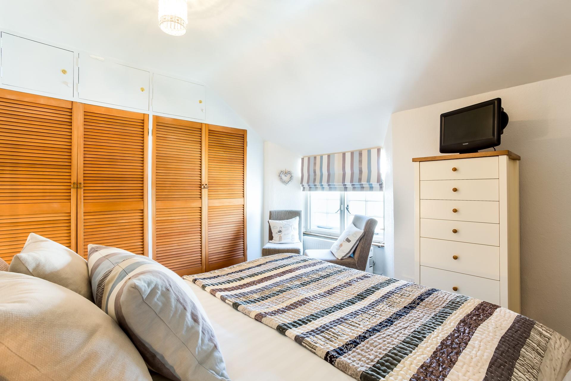 Settle into bed and put the TV on for a relaxing evening.