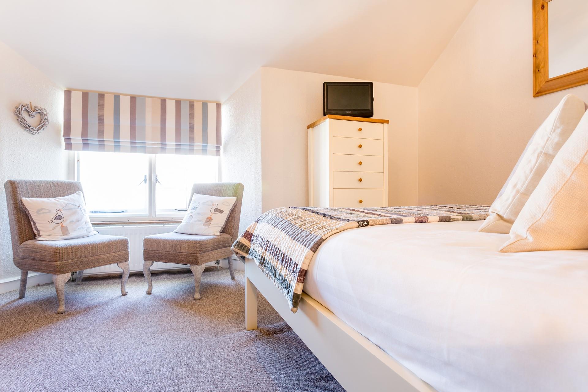 Sit in the chairs in the window and look out at the views.