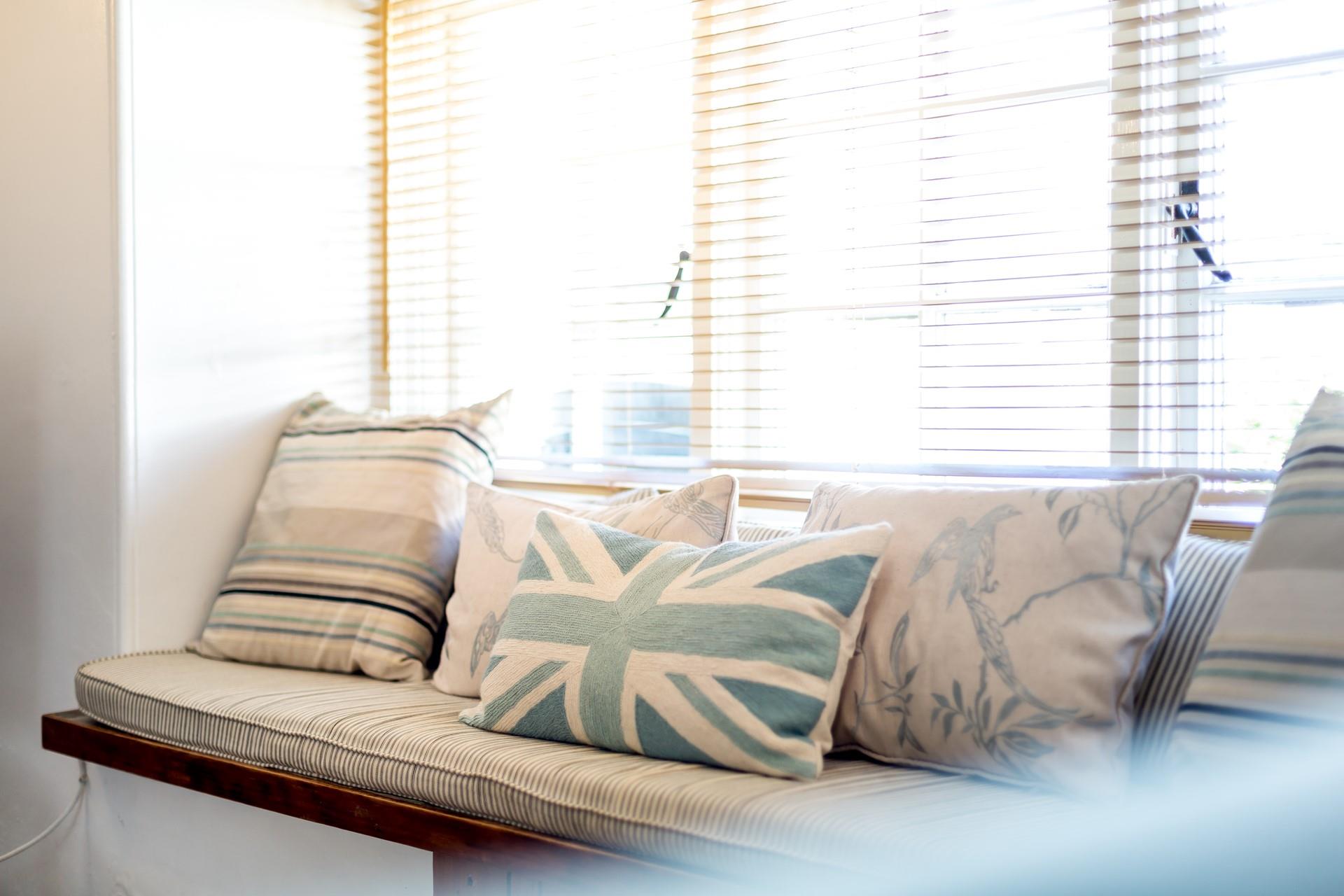 People watch from the cushioned window seat.