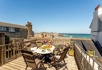 Lovely sea-view decking area at the rear of the cottage with quality patio furniture including reclining chairs.