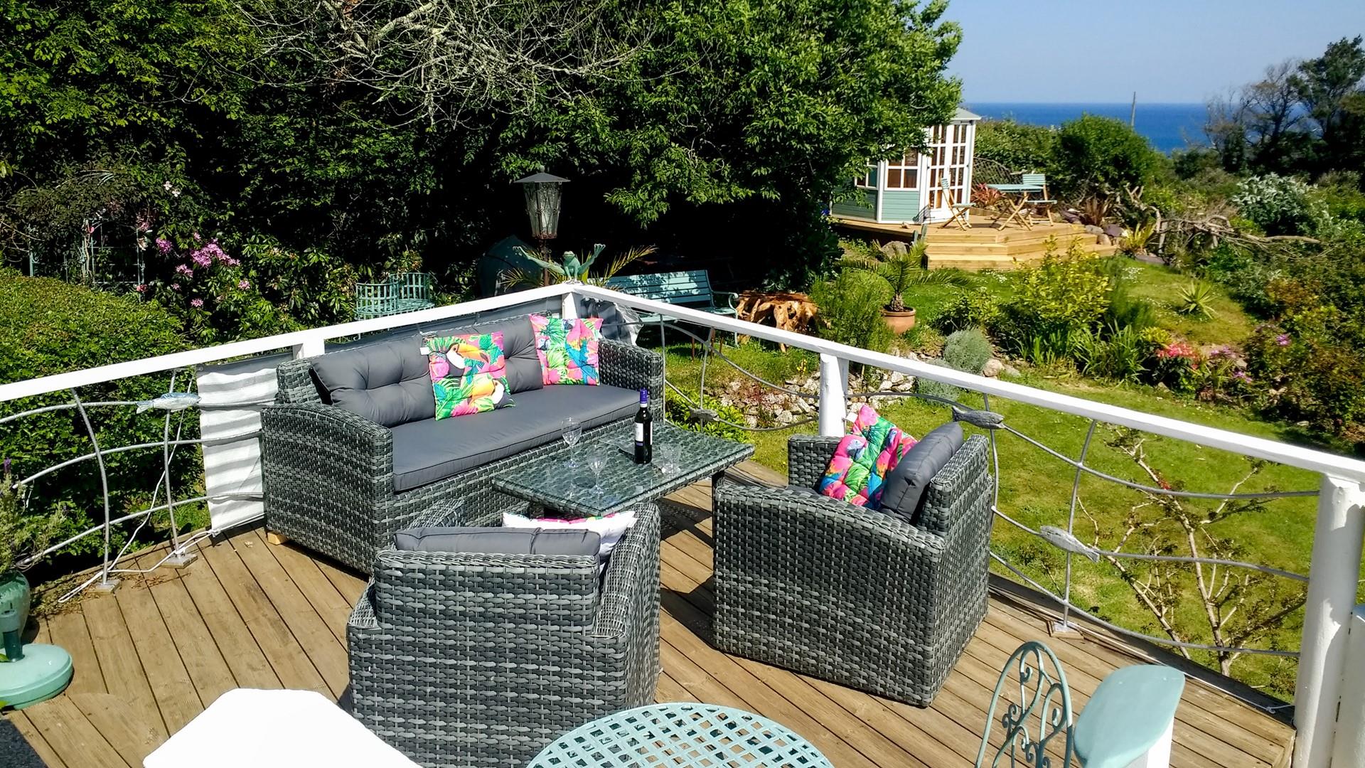 Dine alfresco on the terrace overlooking the garden and sea views. 