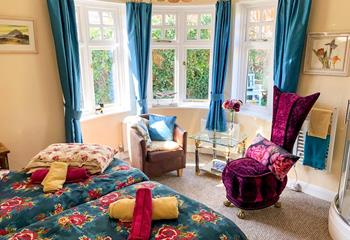 Bright, light and colourful, bedroom 1 benefits from three large windows and a corner shower. 