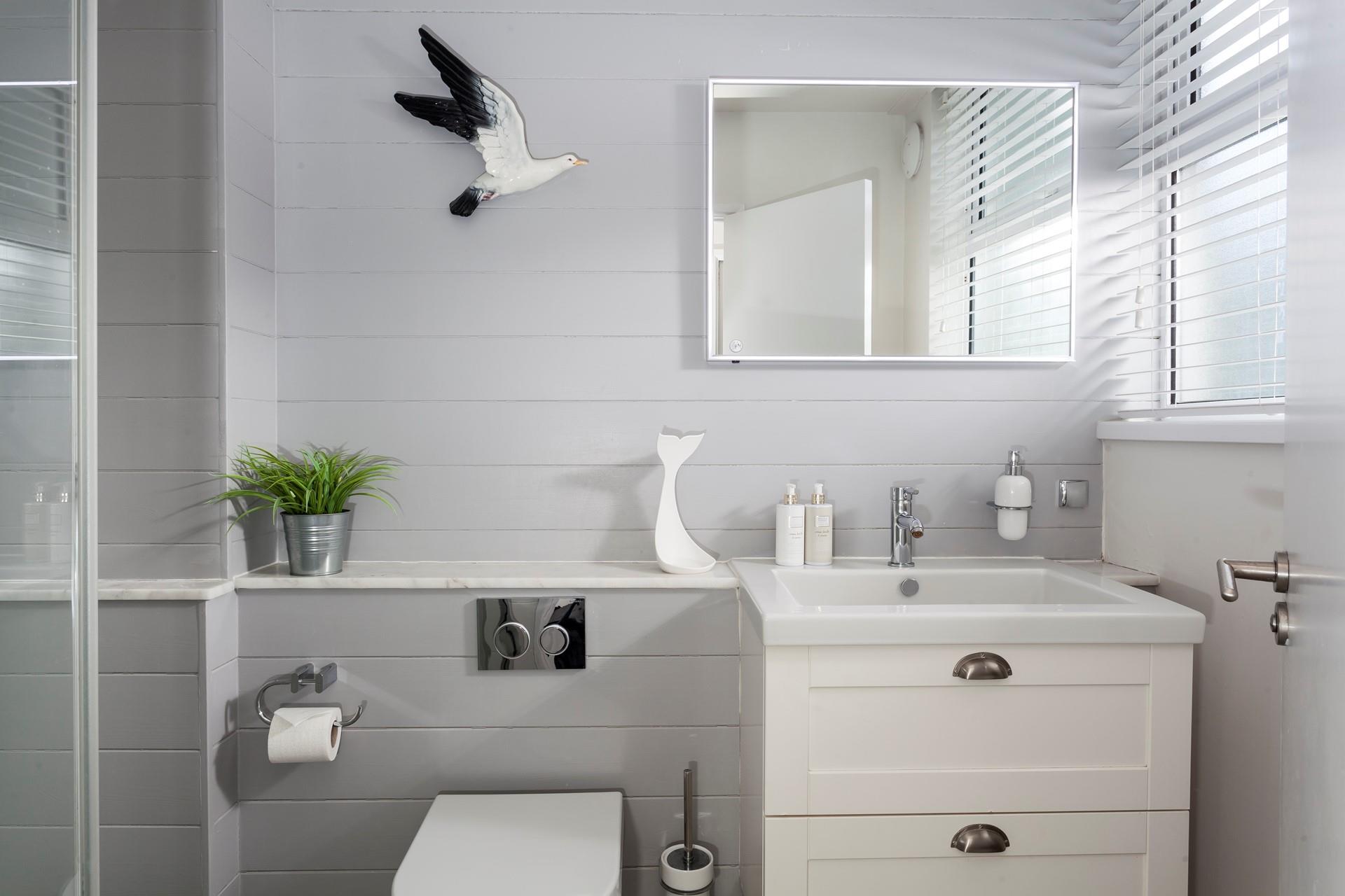 Decorated in cool, coastal tones, the bathroom is the perfect place to pamper yourself before a night out.