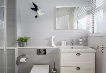 Decorated in cool, coastal tones, the bathroom is the perfect place to pamper yourself before a night out.