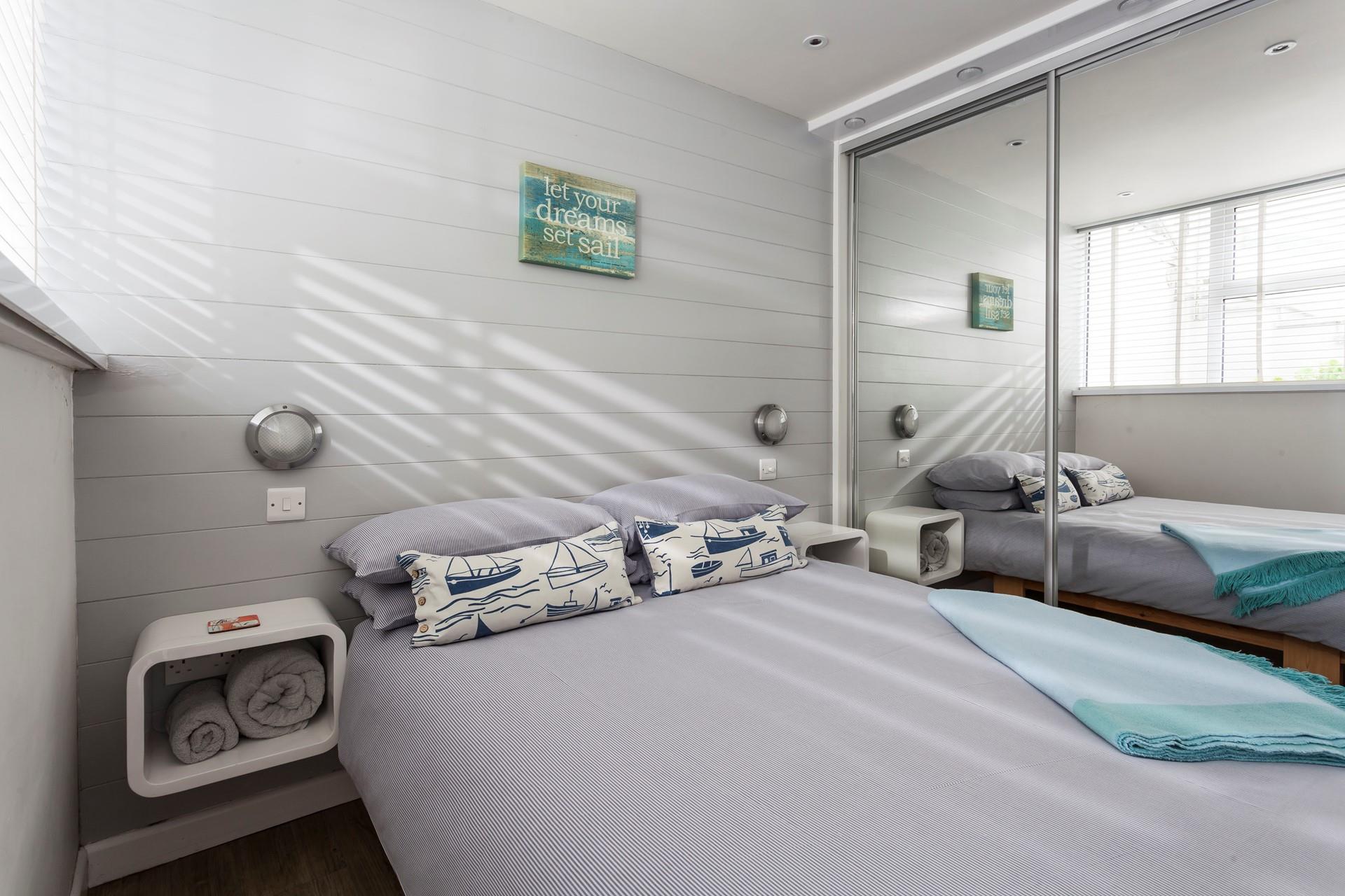 Built-in bed, with 1000 pocket sprung mattress. Please note the bed fits snugly end to end between the walls. With quirky storage and a feature wall creating the feeling of actually being on a ship.