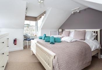 Slanted ceilings give this room extra character whilst the king size bed promises a peaceful night's sleep.