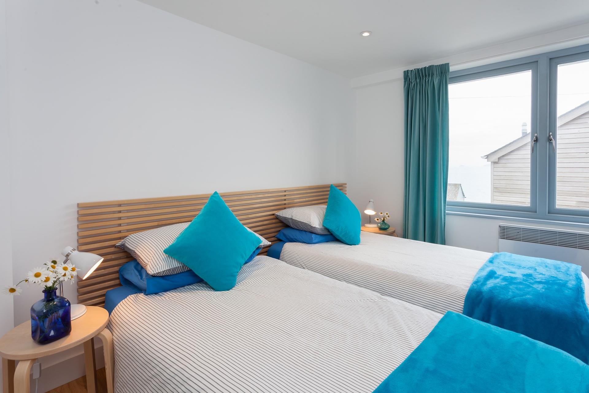Bedroom 1 is located on the first floor and features twin beds, wake up to views of Porthgwidden.