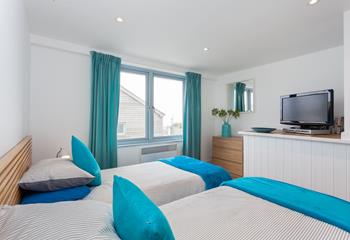 The twin bedroom continues the seaside theme with blue interiors.
