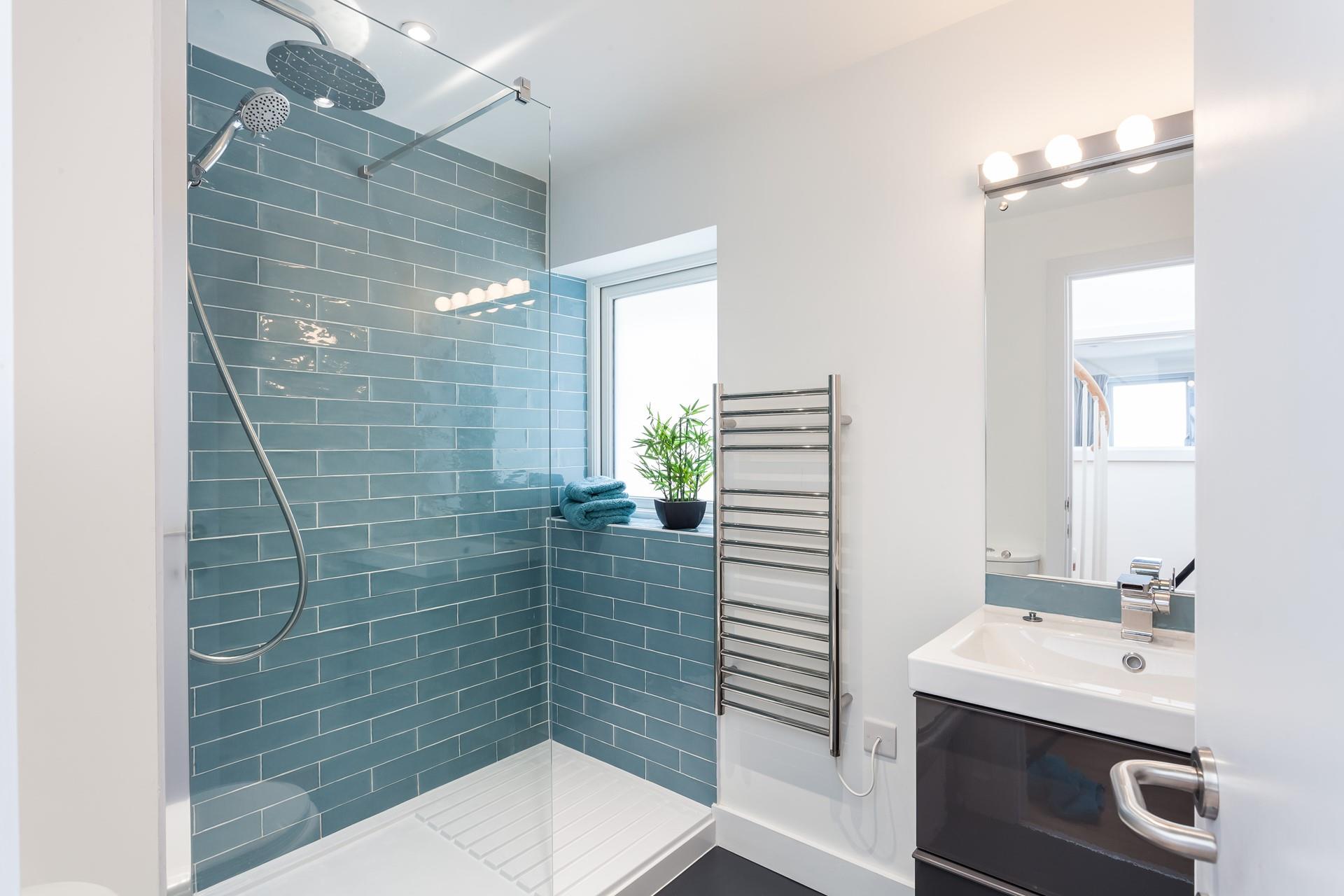 The shower room has a large walk-in shower, WC and basin.