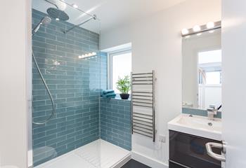 The shower room has a large walk-in shower, WC and basin.