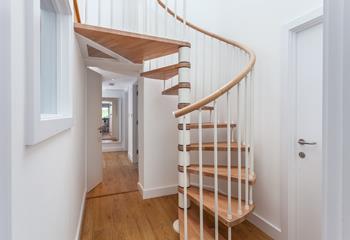 A stylish spiral staircase leads to the top floor.