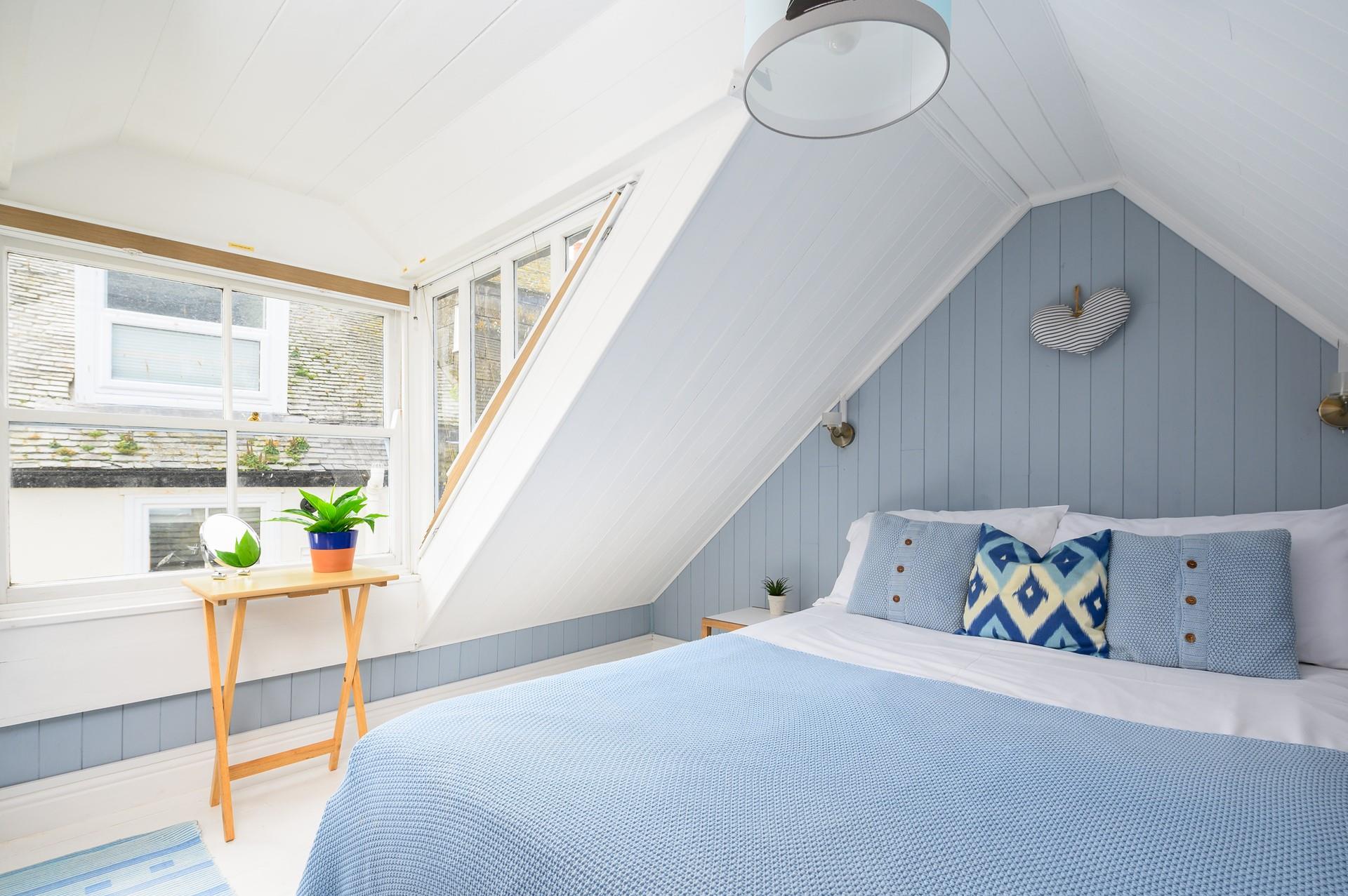 Serene and calming blue bedroom in the eaves to bring the sea to you.