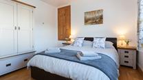 The gorgeous bedroom is wonderfully spacious, offering ample room for your holiday attire.