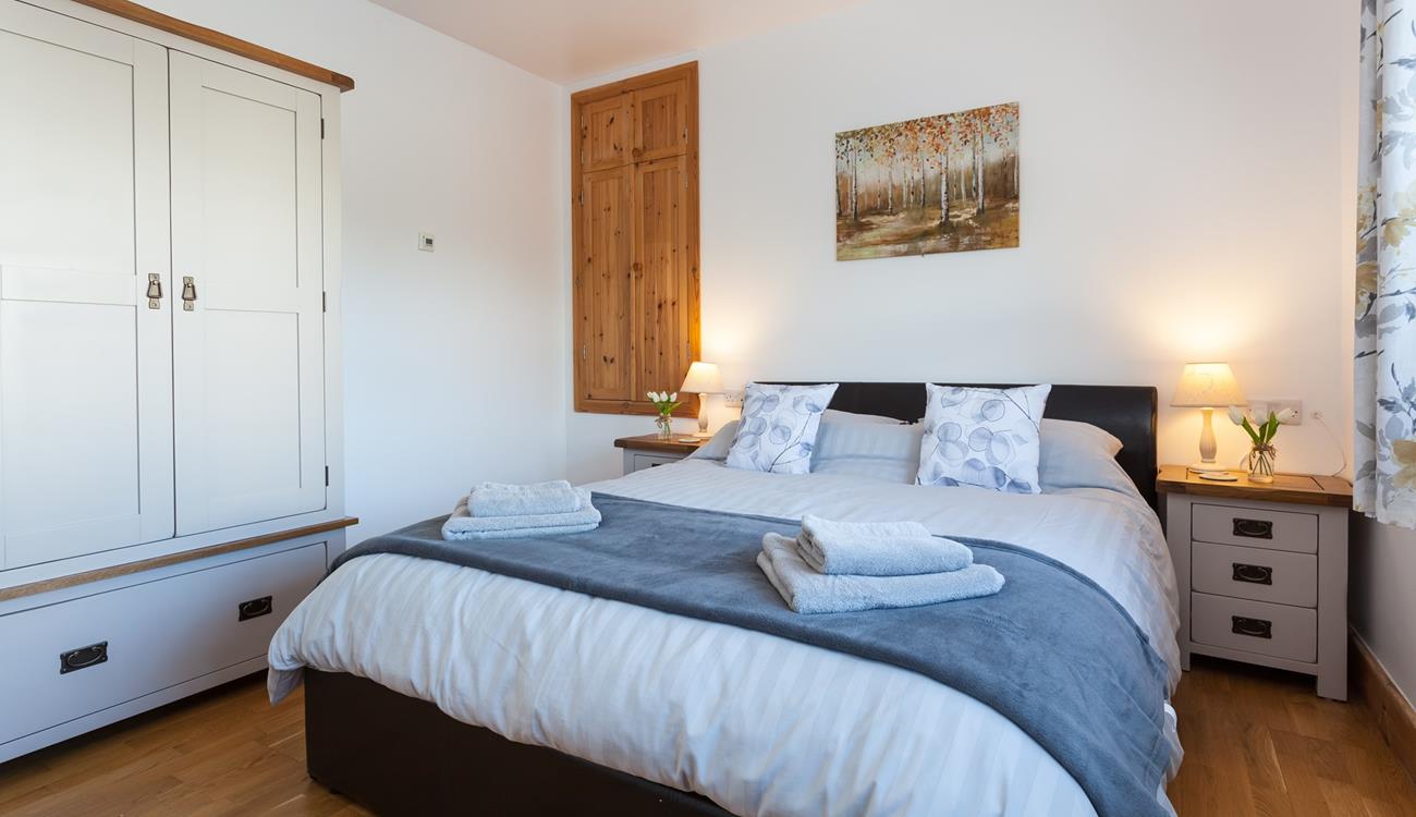 The gorgeous bedroom is wonderfully spacious, offering ample room for your holiday attire.