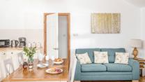 Classic furniture and country cottage tones give the sitting room a warm and welcoming feel.