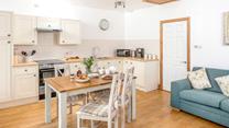 The dining area offers ample space to enjoy delicious home-cooked meals.