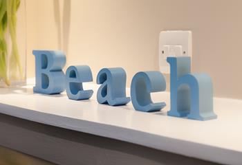 Lovely 3D wooden letters spell out what this holiday home is all about; spending time by the seaside.