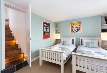 The lower ground floor has a twin bedroom with calming pastel interiors.