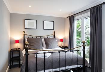 Patio doors let in an abundance of light into this bedroom.