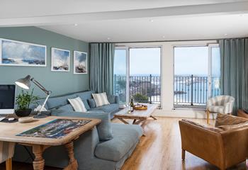 Full-length sliding doors to decked balcony with sea and harbour view from the sitting room.