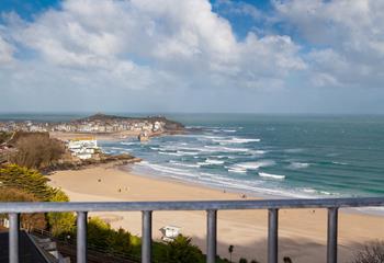 Sit on your balcony and gaze out at the waves rolling onto shore.