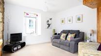 Cute countryside decor and soft natural tones have created a comforting rural cottage feel.