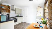 The kitchen table can be folded out, creating more room to enjoy meals together.