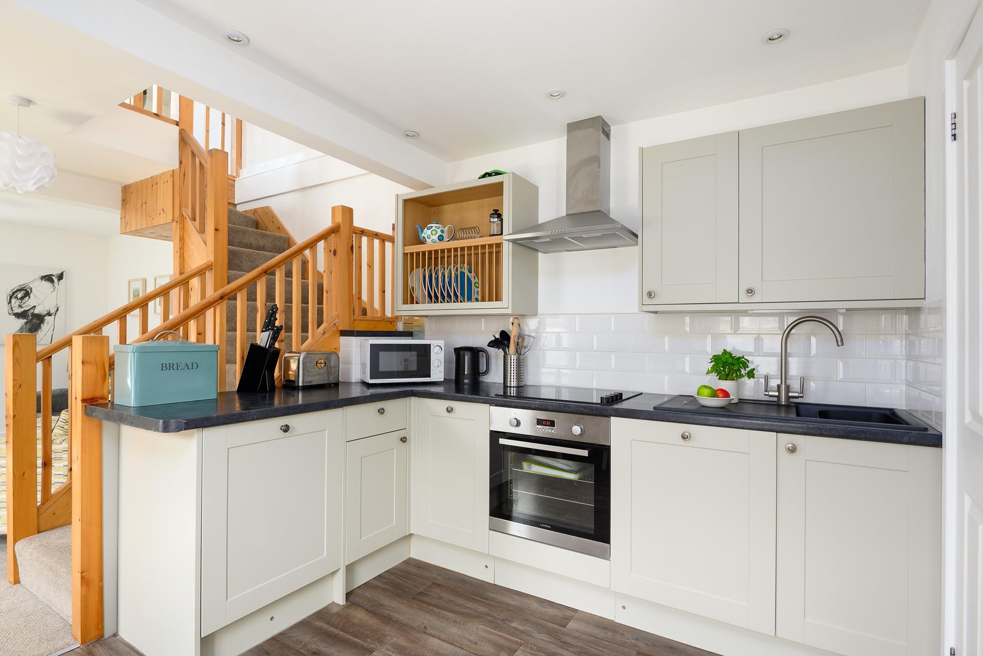 The kitchen has been carefully designed to maximise space and is fully equipped with modern appliances.