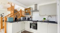 The kitchen has been carefully designed to maximise space and is fully equipped with modern appliances.