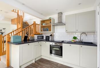 The kitchen has been carefully designed to maximise space and is fully equipped with modern appliances.