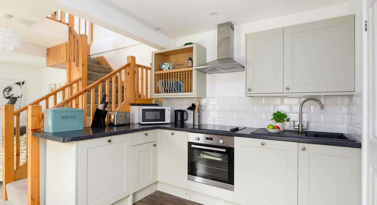 The kitchen has been carefully designed to maximise space and is fully equipped with modern appliances.