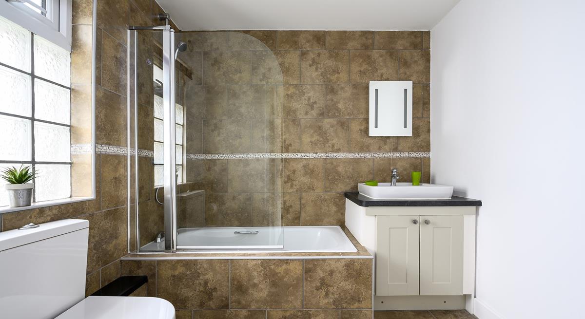 The bathroom is generously sized with a fabulous bath and shower over, perfect for washing the sand away after a day at the beach.