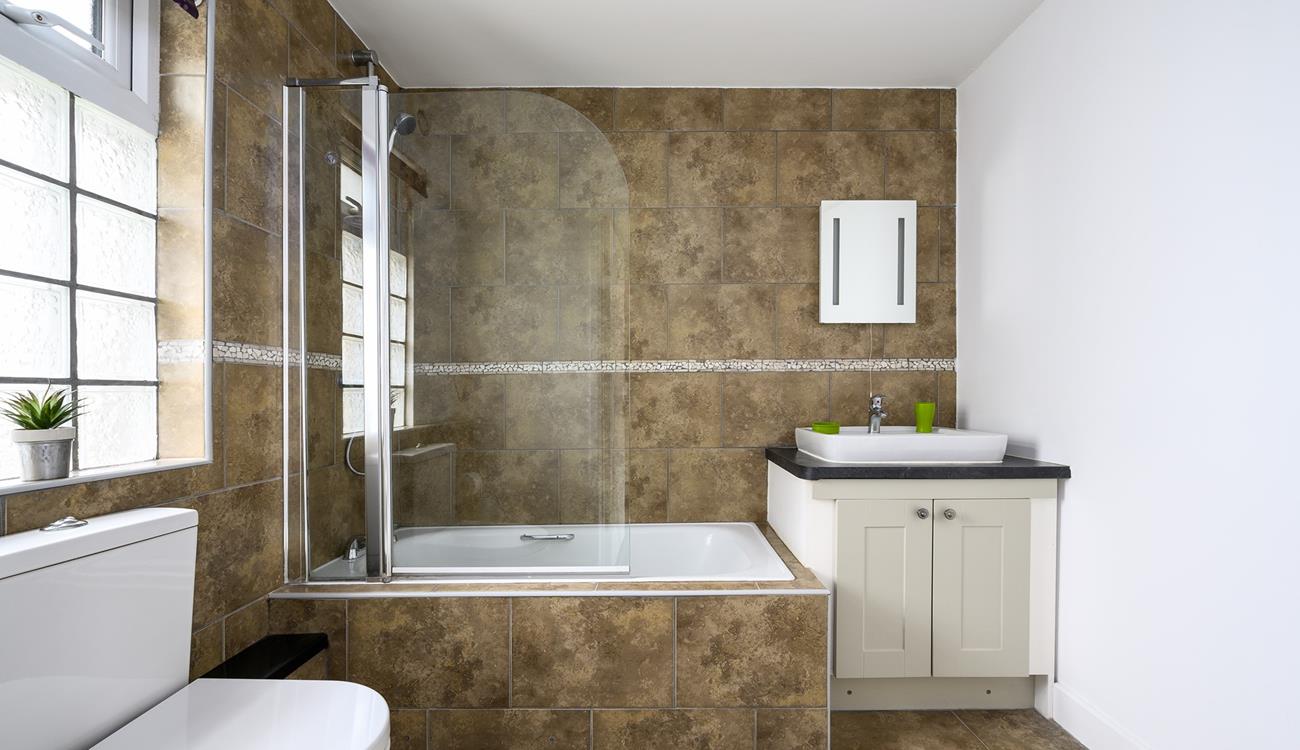 The bathroom is generously sized with a fabulous bath and shower over, perfect for washing the sand away after a day at the beach.