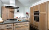 The kitchen is spacious and well-equipped for all your culinary needs. - Thumbnail Image