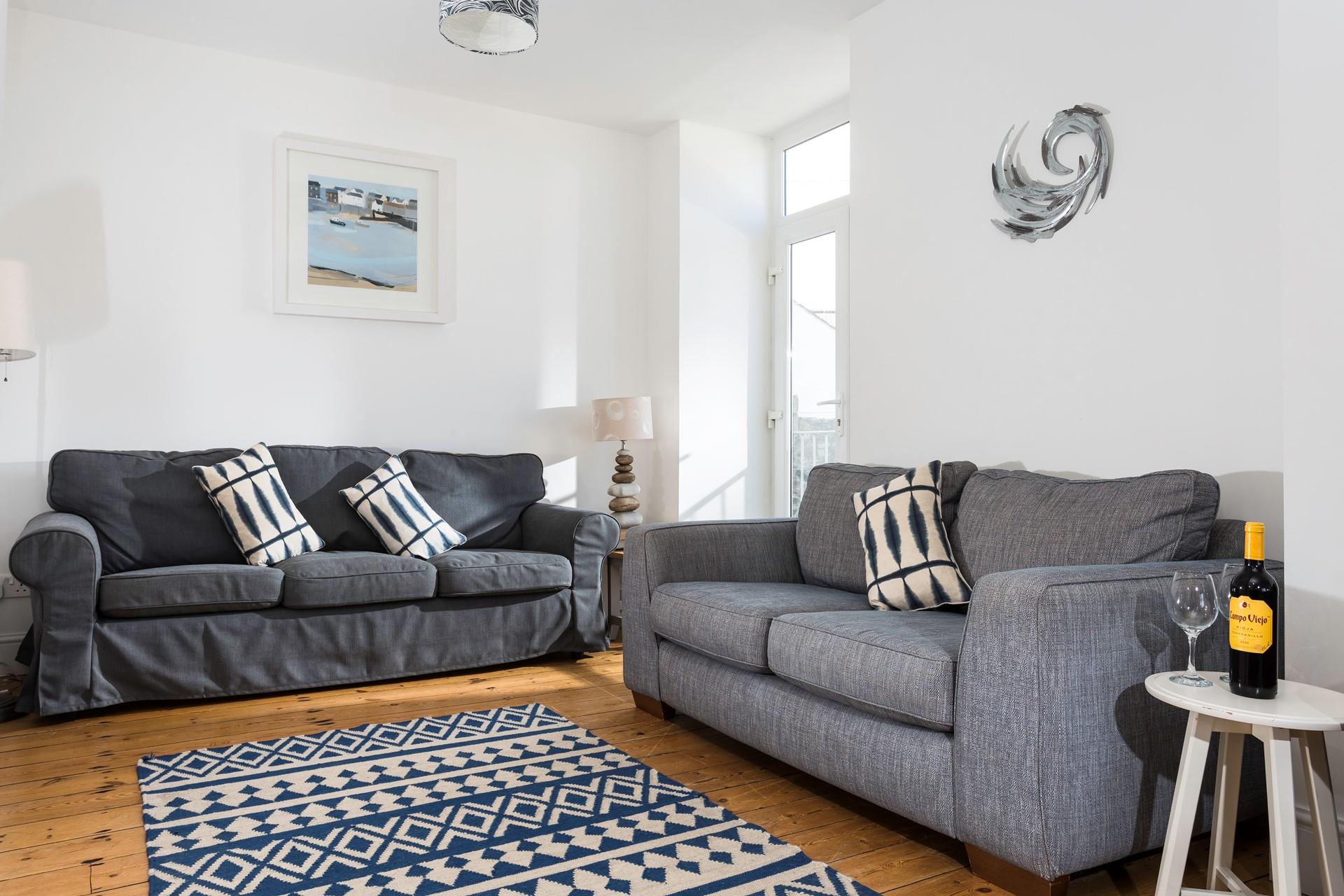 Lovely Cornish artwork fills the walls of the sitting room.