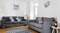 Lovely Cornish artwork fills the walls of the sitting room.