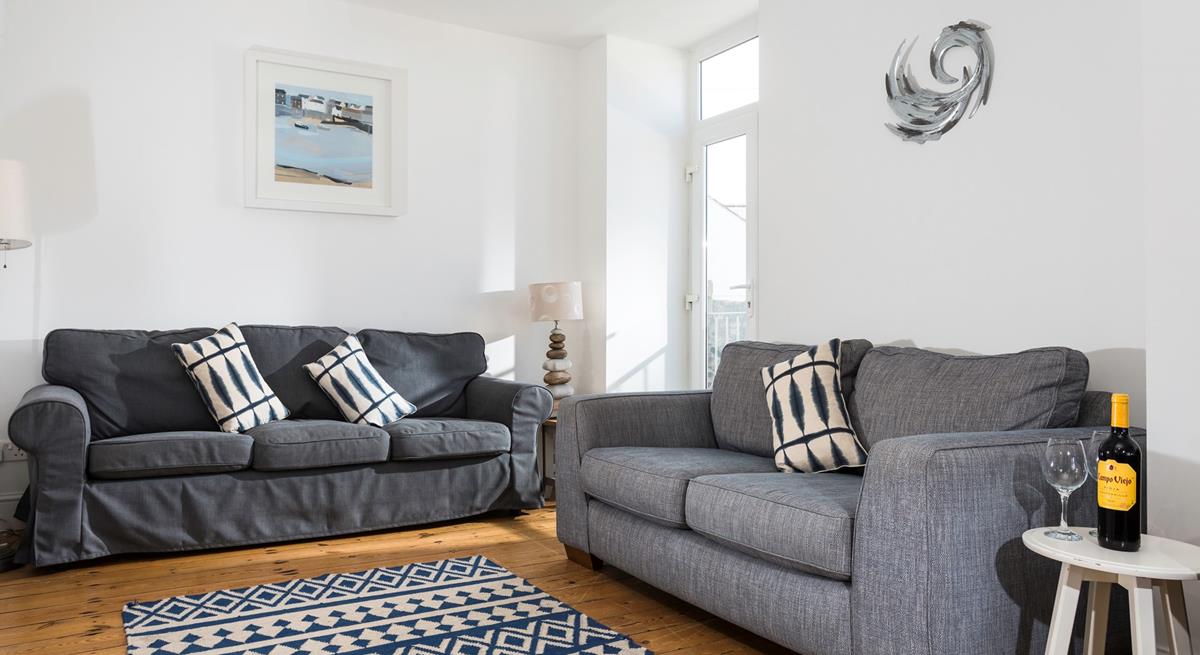 Lovely Cornish artwork fills the walls of the sitting room.