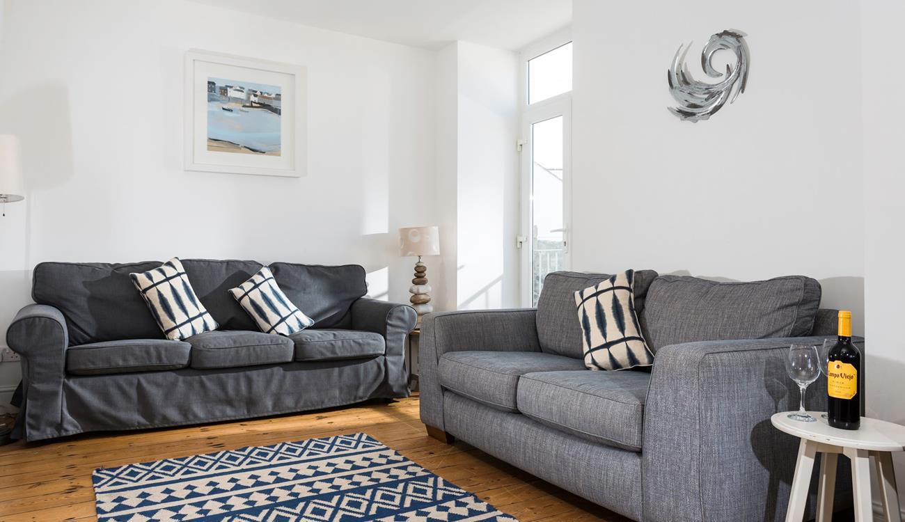 Lovely Cornish artwork fills the walls of the sitting room.