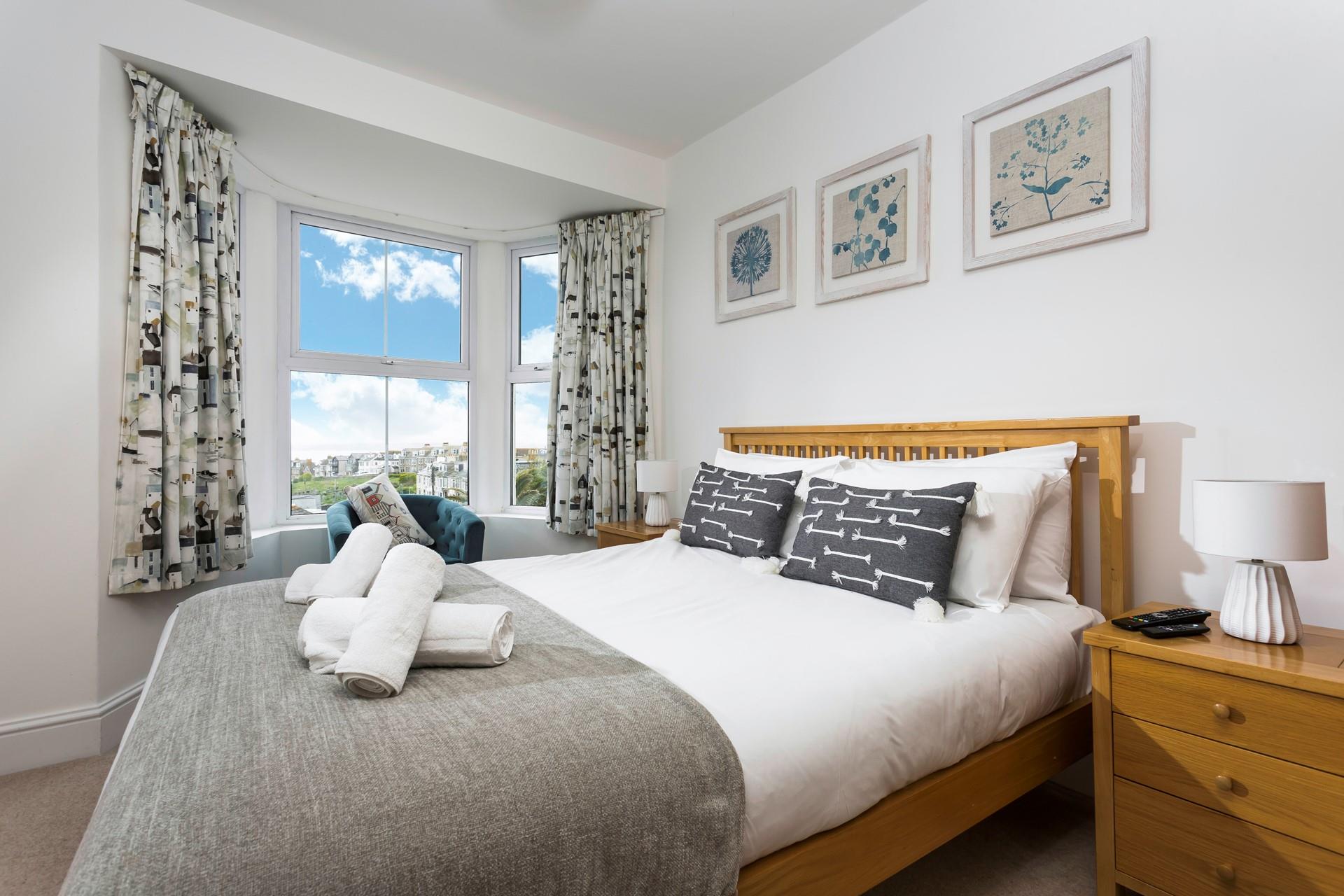 Bedroom 3 is decorated with a blue and white colour scheme creating a calming space.