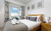 Bedroom 3 is decorated with a blue and white colour scheme creating a calming space. - Thumbnail Image