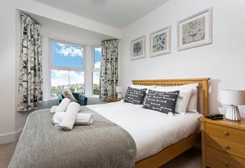 Bedroom 3 is decorated with a blue and white colour scheme creating a calming space.