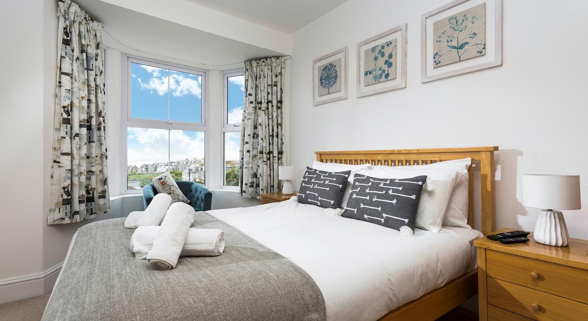 Bedroom 3 is decorated with a blue and white colour scheme creating a calming space.