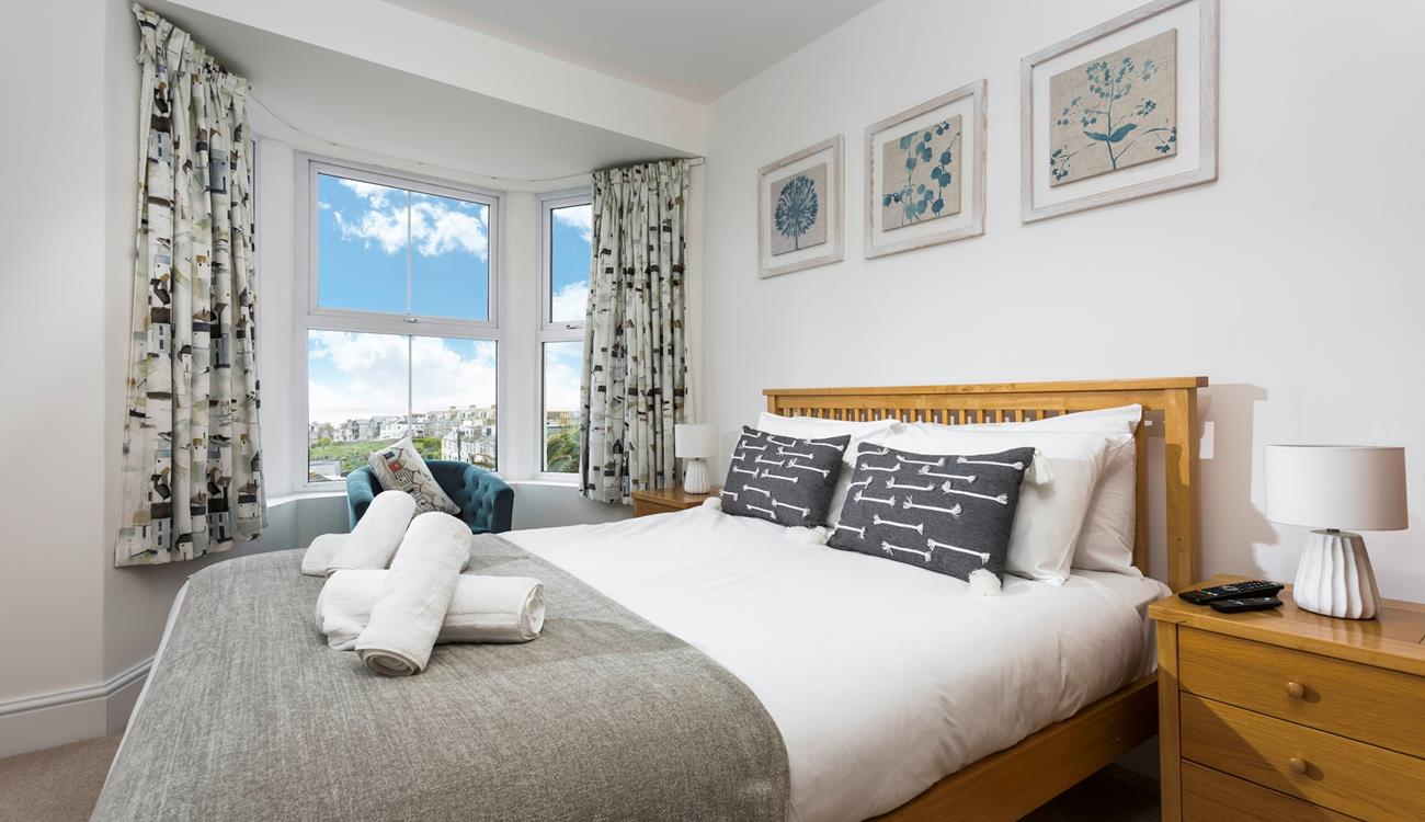 Bedroom 3 is decorated with a blue and white colour scheme creating a calming space.