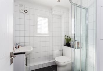The shower room is modern and sleek, perfect for washing off sandy toes.