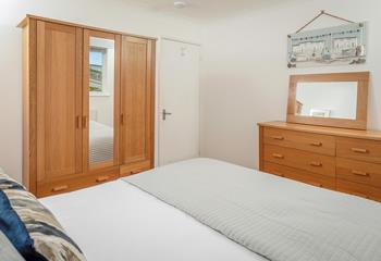 Light and airy, bedroom 1 has plenty of room and storage for your time here. 