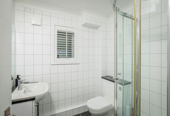 The shower room is modern and sleek, perfect for washing off sandy toes.